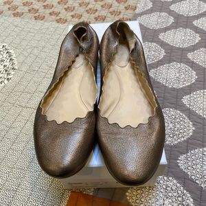 Chloe gold scalloped flats.